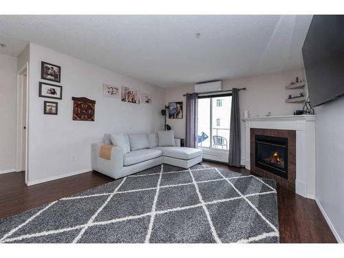 313-260 Shawville Way Se, Calgary, AB - Indoor Photo Showing Living Room With Fireplace