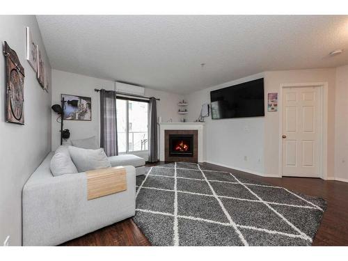 313-260 Shawville Way Se, Calgary, AB - Indoor Photo Showing Living Room With Fireplace