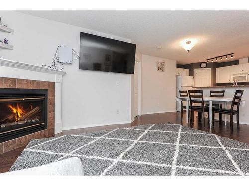 313-260 Shawville Way Se, Calgary, AB - Indoor Photo Showing Living Room With Fireplace