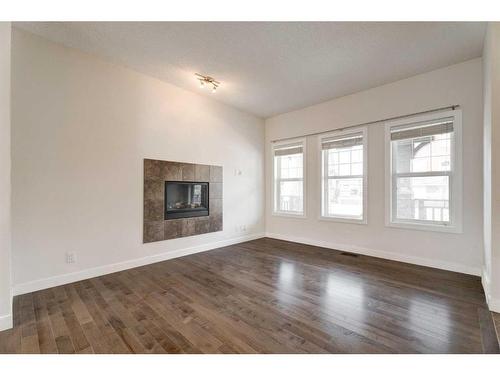 174 Clydesdale Way, Cochrane, AB - Indoor Photo Showing Other Room With Fireplace