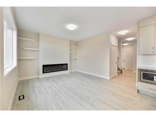 486 Clydesdale Way, Cochrane, AB - Indoor Photo Showing Other Room With Fireplace