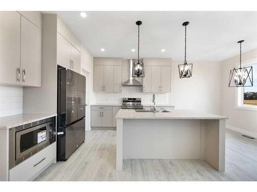 486 Clydesdale Way, Cochrane, AB - Indoor Photo Showing Kitchen With Stainless Steel Kitchen With Upgraded Kitchen