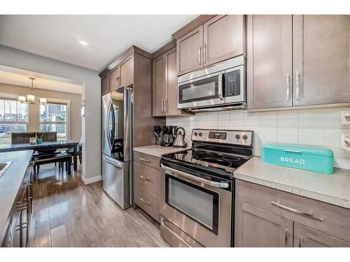 73 Fireside Bend, Cochrane, AB - Indoor Photo Showing Kitchen With Stainless Steel Kitchen With Upgraded Kitchen