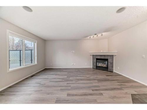 135 Cougarstone Square Sw, Calgary, AB - Indoor With Fireplace