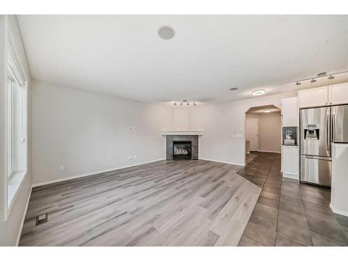 135 Cougarstone Square Sw, Calgary, AB - Indoor With Fireplace