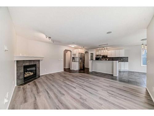 135 Cougarstone Square Sw, Calgary, AB - Indoor Photo Showing Living Room With Fireplace