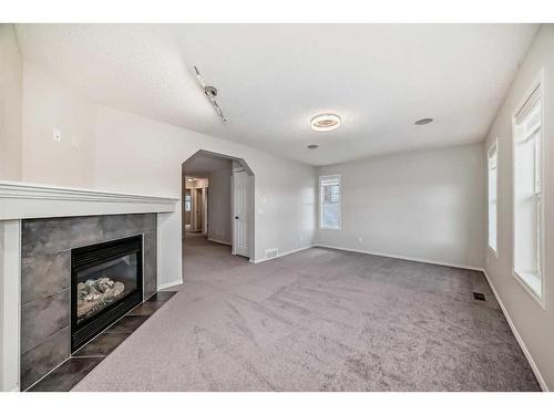 135 Cougarstone Square Sw, Calgary, AB - Indoor With Fireplace