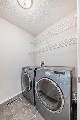 135 Cougarstone Square Sw, Calgary, AB - Indoor Photo Showing Laundry Room