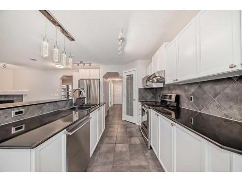 135 Cougarstone Square Sw, Calgary, AB - Indoor Photo Showing Kitchen With Double Sink With Upgraded Kitchen