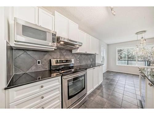 135 Cougarstone Square Sw, Calgary, AB - Indoor Photo Showing Kitchen