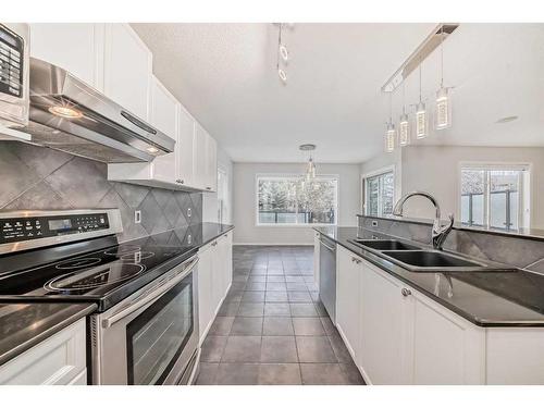 135 Cougarstone Square Sw, Calgary, AB - Indoor Photo Showing Kitchen With Double Sink With Upgraded Kitchen