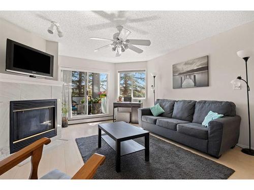 206-30 Sierra Morena Mews Sw, Calgary, AB - Indoor Photo Showing Living Room With Fireplace