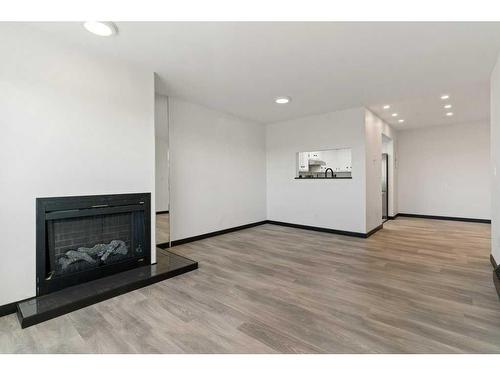 305-3727 42 Street Nw, Calgary, AB - Indoor Photo Showing Living Room With Fireplace