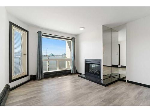 305-3727 42 Street Nw, Calgary, AB - Indoor Photo Showing Living Room With Fireplace