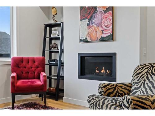 970 Harmony Parade, Rural Rocky View County, AB - Indoor Photo Showing Living Room With Fireplace