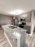 1416-4641 128 Avenue Ne, Calgary, AB  - Indoor Photo Showing Kitchen With Stainless Steel Kitchen With Double Sink With Upgraded Kitchen 