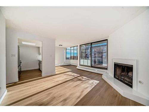 302-345 4 Avenue Ne, Calgary, AB - Indoor Photo Showing Other Room With Fireplace