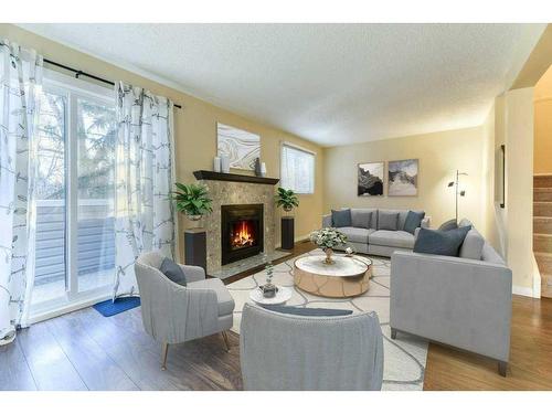 65-200 Shawnessy Drive Sw, Calgary, AB - Indoor Photo Showing Living Room With Fireplace