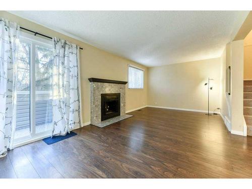 65-200 Shawnessy Drive Sw, Calgary, AB - Indoor Photo Showing Living Room With Fireplace