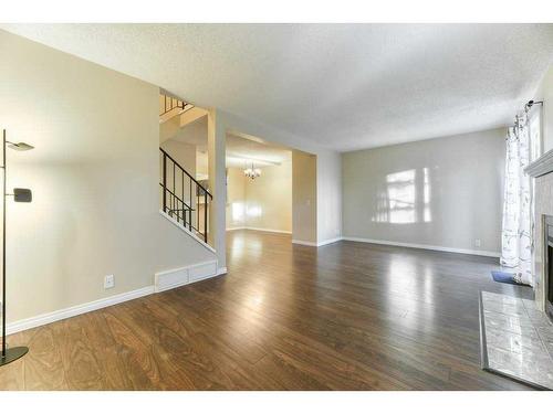 65-200 Shawnessy Drive Sw, Calgary, AB - Indoor Photo Showing Living Room With Fireplace