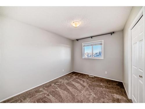 34 Sunset Heights, Cochrane, AB - Indoor Photo Showing Other Room