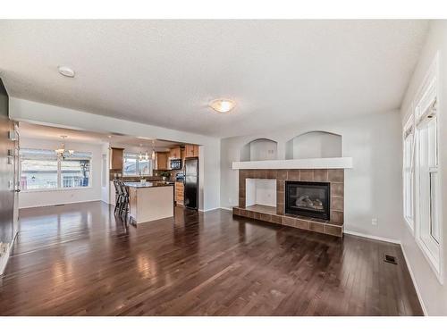 34 Sunset Heights, Cochrane, AB - Indoor Photo Showing Living Room With Fireplace