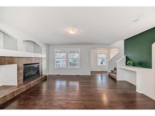 34 Sunset Heights, Cochrane, AB - Indoor Photo Showing Living Room With Fireplace