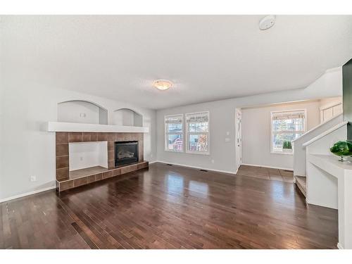 34 Sunset Heights, Cochrane, AB - Indoor Photo Showing Living Room With Fireplace