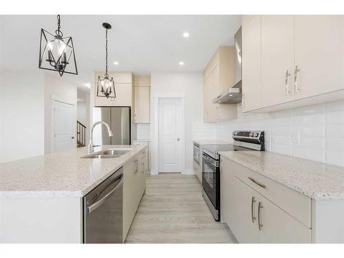 494 Clydesdale Way, Cochrane, AB - Indoor Photo Showing Kitchen With Double Sink With Upgraded Kitchen