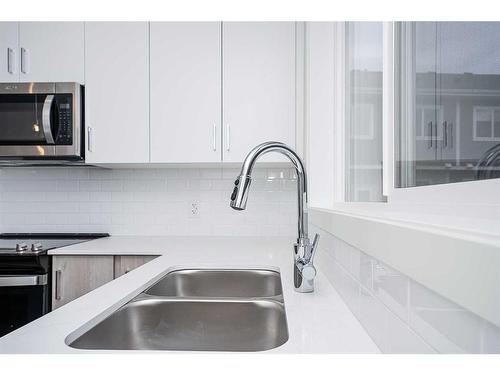 412-137 Red Embers Link Ne, Calgary, AB - Indoor Photo Showing Kitchen With Double Sink