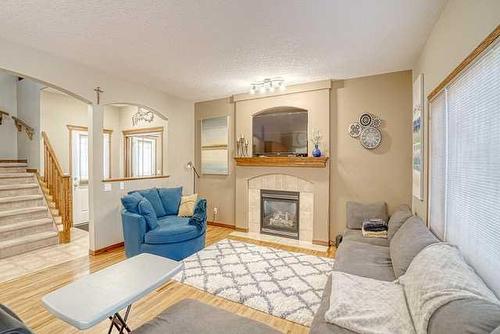 83 Sunset Circle, Cochrane, AB - Indoor Photo Showing Living Room With Fireplace