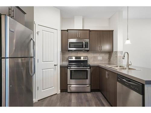 118 Copperpond Landing Se, Calgary, AB - Indoor Photo Showing Kitchen With Stainless Steel Kitchen With Double Sink