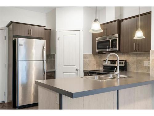 118 Copperpond Landing Se, Calgary, AB - Indoor Photo Showing Kitchen With Stainless Steel Kitchen With Double Sink