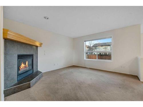 143 Brightondale Crescent Se, Calgary, AB - Indoor Photo Showing Living Room With Fireplace