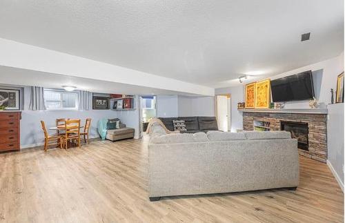 151 Somerglen Common Sw, Calgary, AB - Indoor Photo Showing Living Room With Fireplace