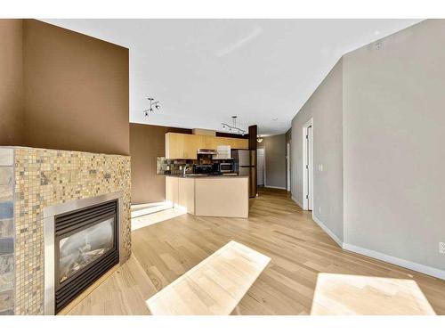 203-108 15 Avenue Se, Calgary, AB - Indoor Photo Showing Living Room With Fireplace