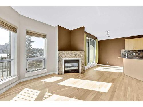 203-108 15 Avenue Se, Calgary, AB - Indoor Photo Showing Living Room With Fireplace