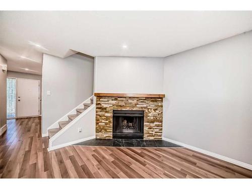 132-7172 Coach Hill Road Sw, Calgary, AB - Indoor Photo Showing Living Room With Fireplace