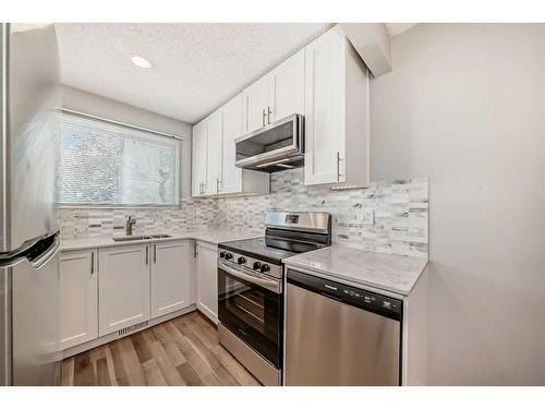 132-7172 Coach Hill Road Sw, Calgary, AB - Indoor Photo Showing Kitchen With Upgraded Kitchen