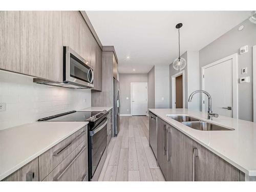 3414-111 Wolf Creek Drive Se, Calgary, AB - Indoor Photo Showing Kitchen With Double Sink With Upgraded Kitchen