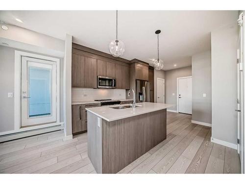 3414-111 Wolf Creek Drive Se, Calgary, AB - Indoor Photo Showing Kitchen With Double Sink