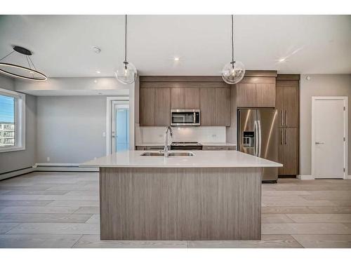 3414-111 Wolf Creek Drive Se, Calgary, AB - Indoor Photo Showing Kitchen With Stainless Steel Kitchen With Double Sink With Upgraded Kitchen