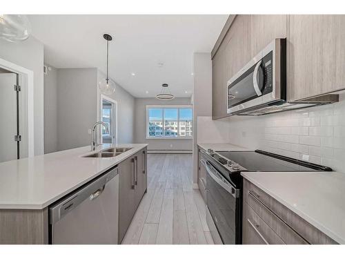 3414-111 Wolf Creek Drive Se, Calgary, AB - Indoor Photo Showing Kitchen With Stainless Steel Kitchen With Double Sink With Upgraded Kitchen