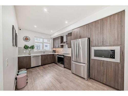 402-8235 8 Ave, Calgary, AB - Indoor Photo Showing Kitchen With Stainless Steel Kitchen