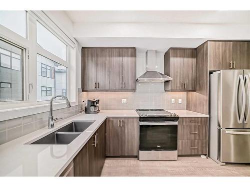 402-8235 8 Ave, Calgary, AB - Indoor Photo Showing Kitchen With Stainless Steel Kitchen With Double Sink With Upgraded Kitchen