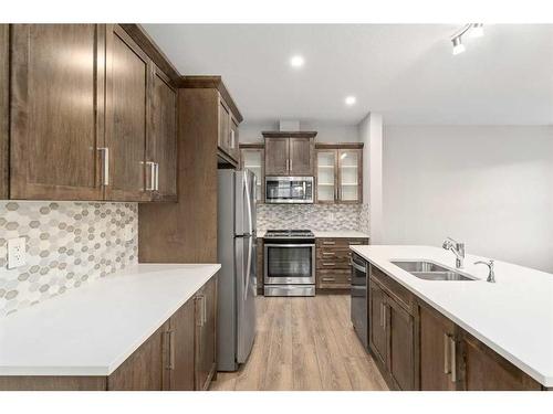 137 Osborne Common Sw, Airdrie, AB - Indoor Photo Showing Kitchen With Double Sink With Upgraded Kitchen