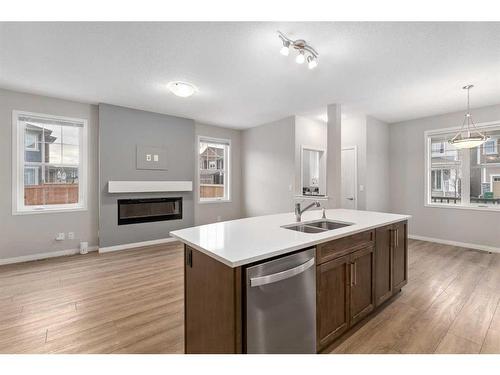 137 Osborne Common Sw, Airdrie, AB - Indoor Photo Showing Kitchen With Fireplace With Double Sink