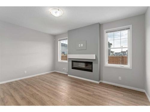 137 Osborne Common Sw, Airdrie, AB - Indoor Photo Showing Living Room With Fireplace