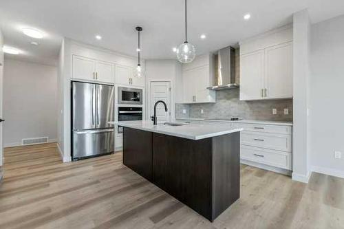 1026 Fowler Road, Airdrie, AB - Indoor Photo Showing Kitchen With Upgraded Kitchen