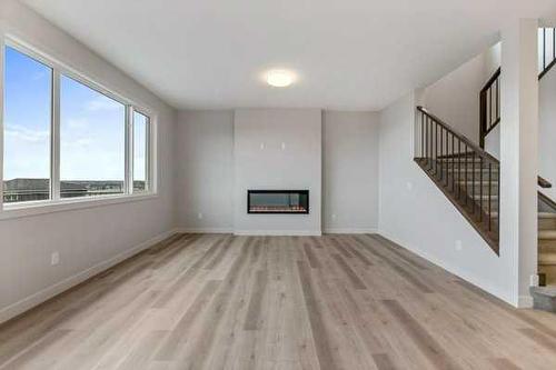 1026 Fowler Road, Airdrie, AB - Indoor Photo Showing Other Room With Fireplace